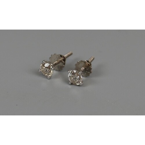 Pair of 18ct white gold ½ct diamond stud earrings