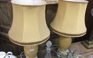 Pair of yellow glazed oviform table lamps with silk shades