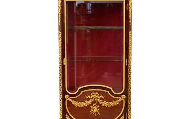 Showcase in mahogany and gilded bronze in Sormani style. France...