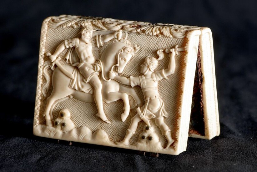 Small book reliquary of ivory dishes carved with landscape decoration of scenes of equestrian fights, the interior revealing a reliquary of rolled paper with cross decoration and oval medallion containing small relics of holy martyrs (Quintian, Maxime...