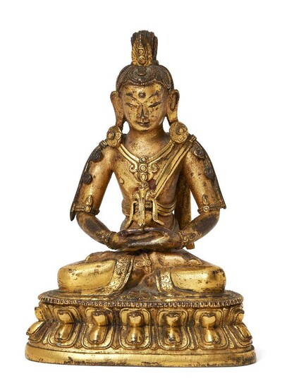 The following fifty lots (36-85) are The Property of a Gentleman A Sino-Tibetan gilt-bronze figure of a bodhisattva, 17th/18th century, finely cast seated in dhyanasana on a double-lotus base, his hands resting in his lap holding a vessel, the...