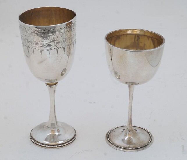 Two silver goblets, one with bright cut engraving, Exeter, 1877, Josiah Williams & Co., 15.6cm high, the other of plain form, Sheffield 1912, Mappin & Webb, 13cm high, total weight approx. 7.2oz (2)