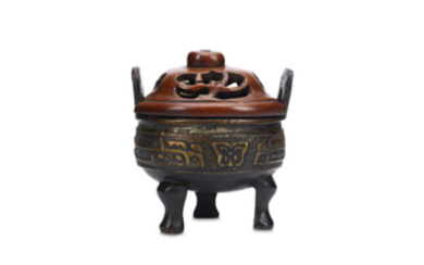 A CHINESE BRONZE CENSER. Qing Dynasty. Supported on...