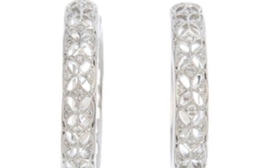 A pair of diamond hoop earrings. Each designed as a