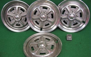Four Rostyle wheel trims for a Triumph 2000 together with rear bumper badge