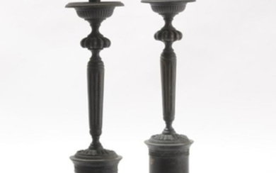 A pair of Neoclassical style metal candlesticks