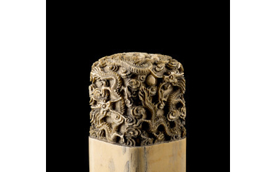 An ivory seal, of square section, carved with five dragons, the base with a seal in archaistic script (slight defects)...