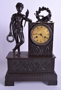 A 19TH CENTURY FRENCH BRONZE MANTEL CLOCK modelled as a