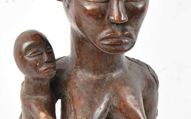A Baule, Ivory Coast, figure holding a child with incised...