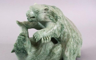 A CHINESE CARVED GREEN HARD STONE MODEL OF TWO PLAYING