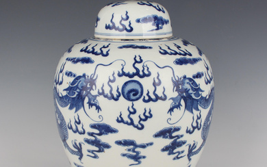 A Chinese blue and white porcelain jar and cover, modern, of stout ovoid form, painted with a pair o