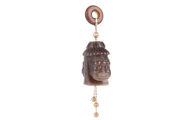 A Chinese carved dark green jade and yellow metal pendant, with double lion mask detail below a lotu
