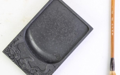 A Chinese dragon themed ink stone together with calligraphy brush