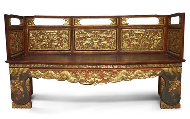 A Chinese gilt lacquered opium bed, early 20th century, with solid bed panel, carved to the railings with panels of mythical beasts amidst trees and flower foliage, 191cm x 106cm x 57cm. 二十世紀早期 木雕漆金床