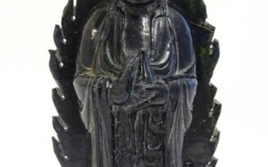 A Chinese nephrite figure modelled as Guanyin holding a
