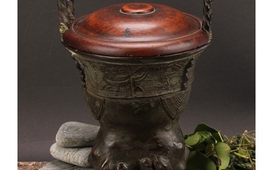 A Chinese patinated bronze ding censer, cast in the archaic ...