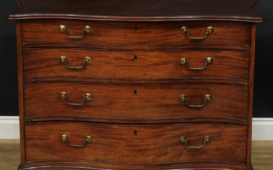 A George III mahogany serpentine chest, slightly oversailing...