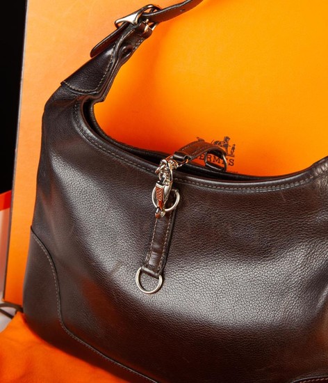 A Hermès Trim Handbag of very dark brown leather with gold coloured metal fittings, in original Herm