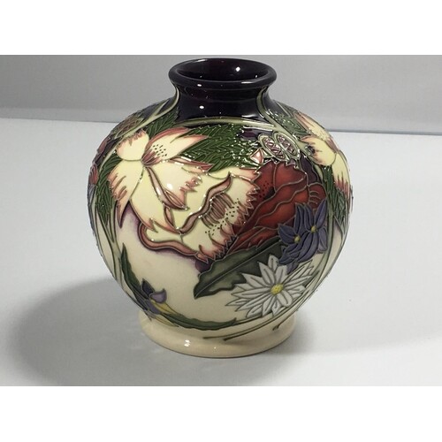 A Moorcroft vase decorated with wild flowers and foliage on ...