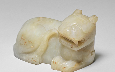 A PALE GREEN JADE CARVING OF A TIGER Song/Yuan Dynasty...