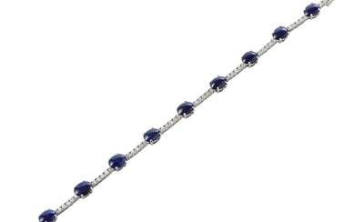 A SAPPHIRE AND DIAMOND BRACELET IN 18CT WHITE GOLD, COMPRISING OVAL CABOCHON CUT SAPPHIRES TOTALLING 15.40CTS, SPACED WITH ROUND BRI...