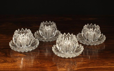 A Set of Four Cut Crystal Lotus Flower Salt Cellars on Stands, with scalloped petal edges (Previousl