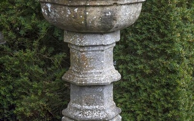 A carved limestone font