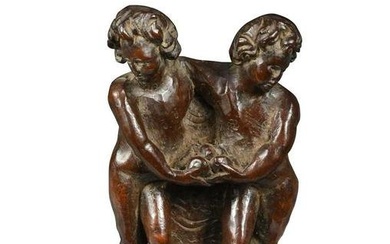 A carved walnut small figure group of two standing Putti, perhaps Flemish 17th century