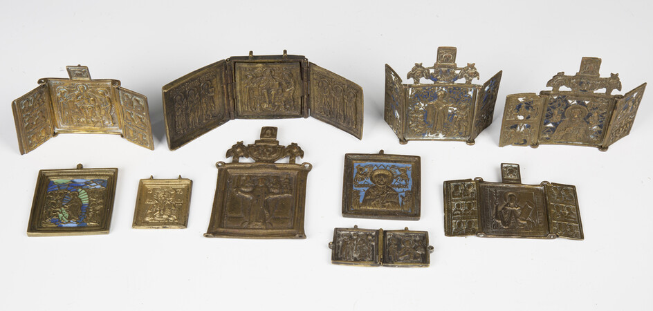 A collection of mainly late 19th century Russian cast brass icons, including two blue enamelled trip