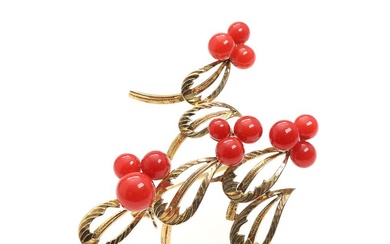 A coral brooch set with cabochon coral, mounted in 8k gold. Weight...