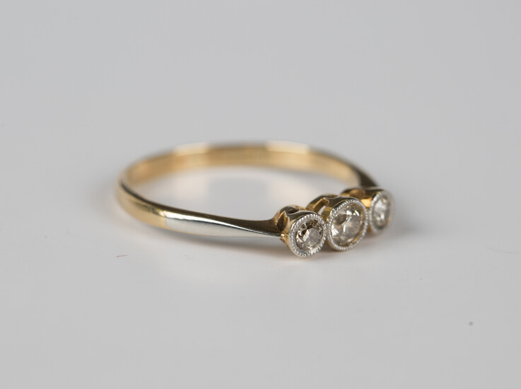 A gold, platinum and diamond three stone ring, collet set with a row of circular cut diamonds, detai