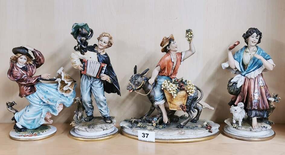 A group of four Capo Di Monte figures, tallest 24cm. Minor finger damage to girl with umbrella and hand repair to the boy on the donkey.