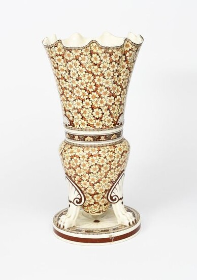 A large Minton's floor vase in the manner of Dr Christopher Dresser, shouldered flaring form with fluted flaring neck, on tripod legs and circular base, printed with flowerhead bands in shades of yellow, brown and green on a white ground impressed...