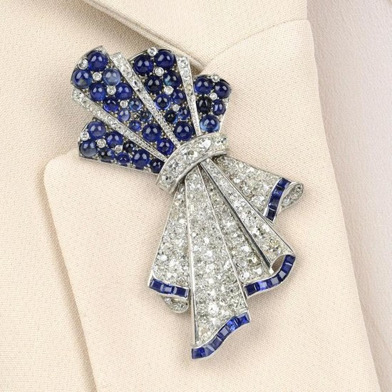 A mid 20th century platinum sapphire and diamond bow