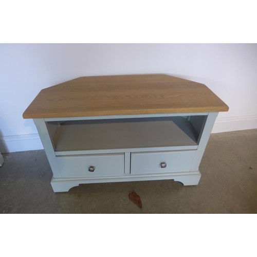A painted corner TV unit with an oak top