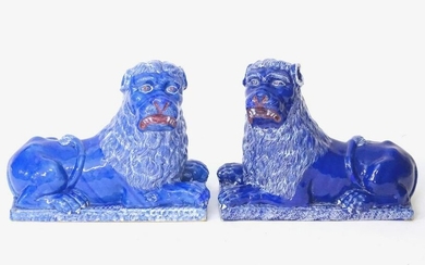 A pair of 19thC faience Luneville lions with a cobalt
