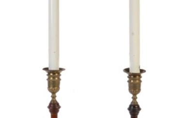 A pair of George III turned mahogany and brass mounted candlesticks