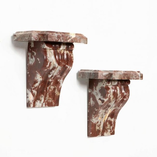 A pair of Neoclassical style marble wall brackets