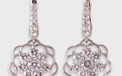 A pair of diamond and platinum drop earrings designed...