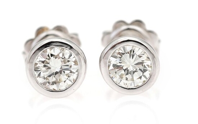 SOLD. A pair of diamond ear studs each set with a diamond weighing a total...