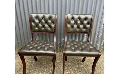 A pair of green leather chesterfield office chairs