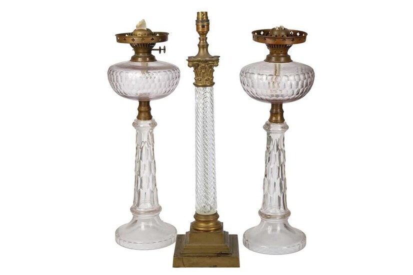 A pair of late 19th century/early 20th century clear glass oil lamp bases