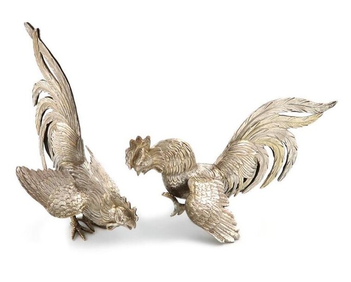 A pair of modern silver fighting cocks, with import marks for London 1963, importer~s mark of I. Freeman and Son Limited, textured feathers with silver-gilt highlights, length 15.5cm, height 13.5cm, approx. weight 7.3oz. (2)