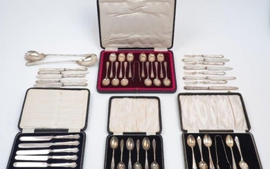 A pair of silver salad servers, Sheffield, 1922, Henry Williamson Ltd., together with: four cased sets of flatware comprising a set of 12 teaspoons with sugar nips, Sheffield, 1919, Cooper Brothers & Sons; a set of silver handled side knives; a set...