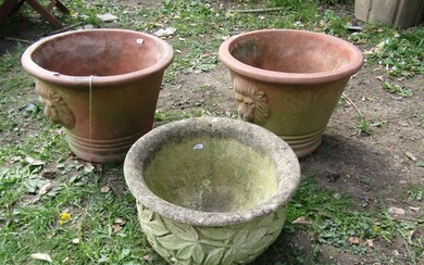 A pair of weathered terracotta garden planters of circular t...