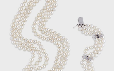 A pearl, sapphire, and fourteen karat white gold necklace...