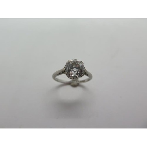 A platinum ring, incorporating a single old cut diamond, siz...