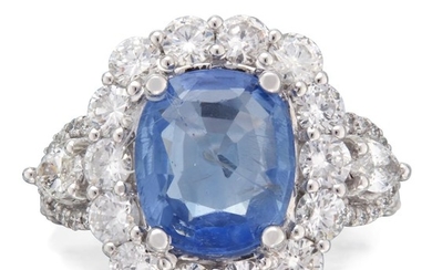 A sapphire, diamond, and eighteen karat white gold ring...