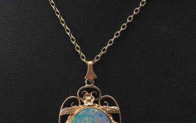 AN ANTIQUE OPAL DOUBLET IN 9CT GOLD, TO A GOLD PLATED CHAIN, LENGTH OF THE PENDANT 25MM, WEIGHT OF THE PENDANT 3.3GMS
