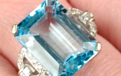 An 18ct gold blue topaz single-stone ring, with vari-cut diamond geometric sides.Topaz calculated